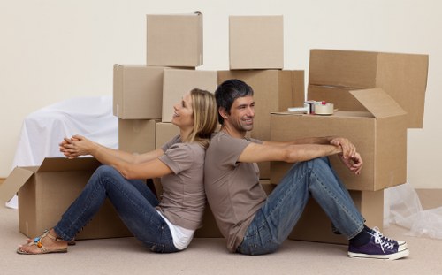 Moving team handling desks and IT equipment during an office relocation